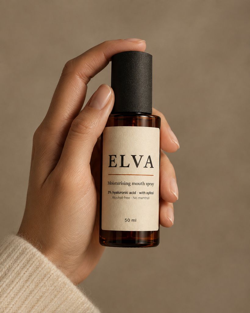 A hand holding a bottle of ELVA moisturising mouth spray